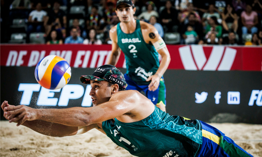 George (à frente) fazendo uma defesa em partida do Circuito Mundial de vôlei de praia (Divulgação/FIVB)